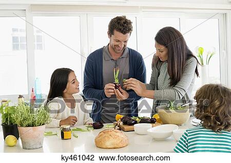 Family preparing food in the kitchen View Large Photo Image Stock Image - Family preparing food in the kitchen. Fotosearch
