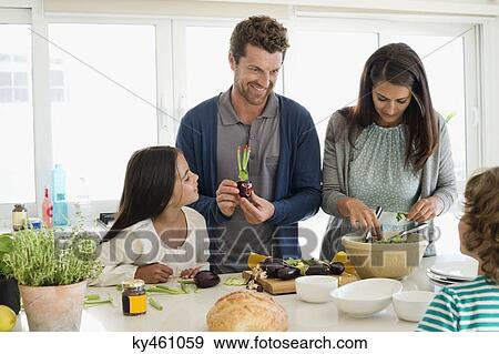 Family preparing food in the kitchen View Large Photo Image Stock Photo - Family preparing food in the kitchen. Fotosearch