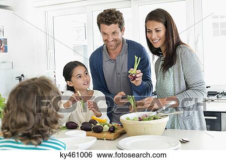 Family preparing food in the kitchen View Large Photo Image Stock Photograph - Family preparing food in the kitchen. Fotosearch