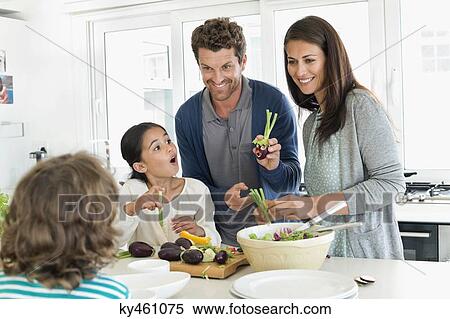 Family preparing food in the kitchen View Large Photo Image Stock Photography - Family preparing food in the kitchen. Fotosearch