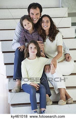 Family sitting on steps and smiling View Large Photo Image Stock Photo - Family sitting on steps and smiling. Fotosearch