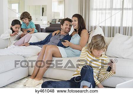 Family using electronics gadget View Large Photo Image Stock Photo - Family using electronics gadget. Fotosearch
