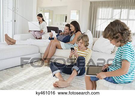 Family using electronics gadget View Large Photo Image Stock Photograph - Family using electronics gadget. Fotosearch