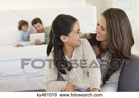 Stock Photo - Mother and daughter smiling at each other. Fotosearch