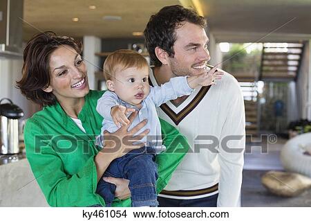 Parents smiling with their son at home View Large Photo Image Picture - Parents smiling with their son at home. Fotosearch