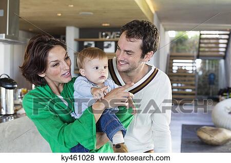 Parents smiling with their son at home View Large Photo Image Stock Photo - Parents smiling with their son at home. Fotosearch