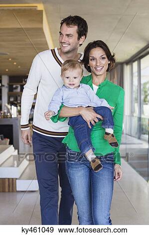 Parents smiling with their son at home View Large Photo Image Stock Photo - Parents smiling with their son at home. Fotosearch