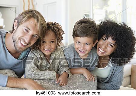 Portrait of a couple smiling with their children View Large Photo Image Stock Image - Portrait of a couple smiling with their children. Fotosearch