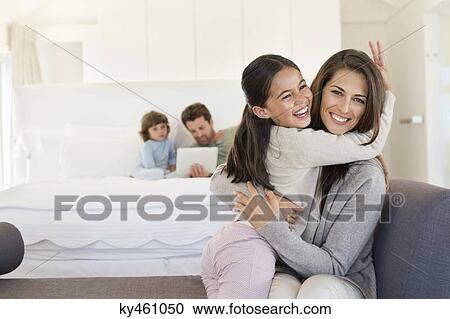 Portrait of a woman hugging her daughter View Large Photo Image Stock Image - Portrait of a woman hugging her daughter. Fotosearch