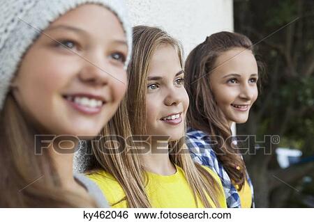 Close-up of three girls smiling together View Large Photo Image Stock Photograph - Close-up of three girls smiling together. Fotosearch