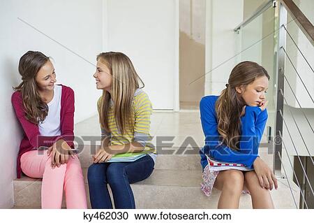 Female friends sitting on stairs in a school View Large Photo Image Stock Image - Female friends sitting on stairs in a school. Fotosearch