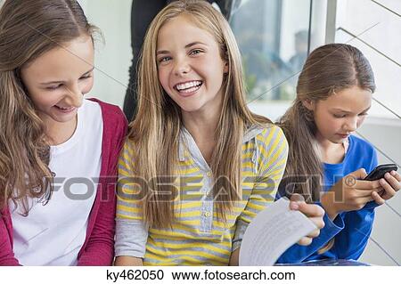Stock Image - Students having fun in a school. Fotosearch