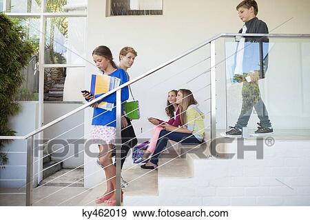 Students using electronic gadget in a school View Large Photo Image Stock Photo - Students using electronic gadget in a school. Fotosearch