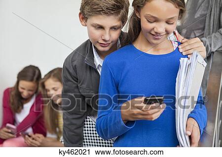 Students using mobile phones in a school View Large Photo Image Stock Image - Students using mobile phones in a school. Fotosearch