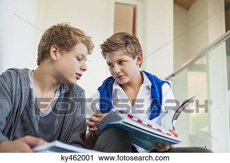 Two teenage boys studying in a school View Large Photo Image Stock Image - Two teenage boys studying in a school. Fotosearch