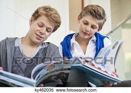 Two teenage boys studying in a school View Large Photo Image Stock Photography - Two teenage boys studying in a school. Fotosearch