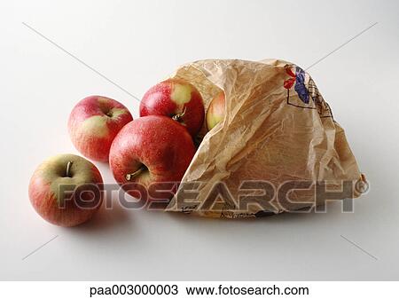 Stock Image - Apples spilling out of paper sack. Fotosearch