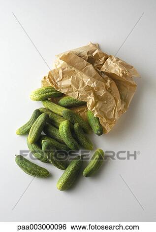 Little cucumbers spilling out of paper sack View Large Photo Image Stock Photograph - Little cucumbers spilling out of paper sack. Fotosearch