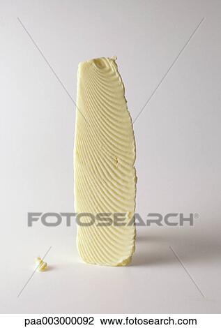Slice of butter standing on end View Large Photo Image Stock Image - Slice of butter standing on end. Fotosearch