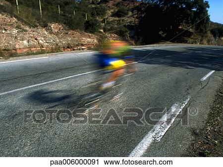 Stock Image - Fast moving cyclist, blurry.. Fotosearch