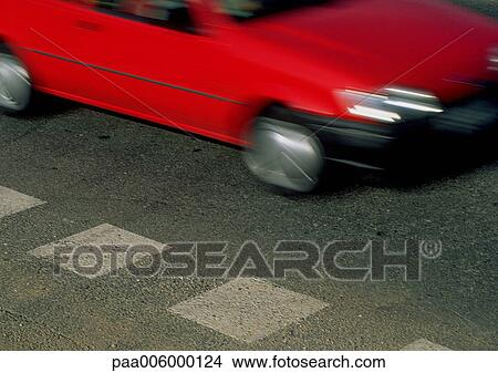 Front of red car in motion, blurry. View Large Photo Image Picture - Front of red car in motion, blurry.. Fotosearch