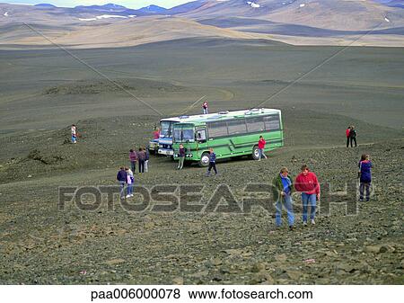 Stock Photo - Iceland, people near bus in mountainous region.. Fotosearch