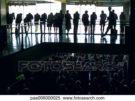 Stock Photography - People standing next to balcony watching people walking below.. Fotosearch