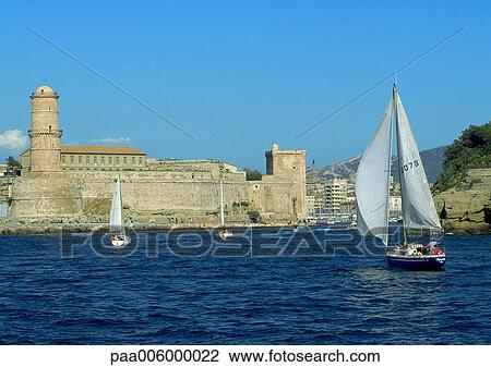 Sailboat on water in front of old fort. View Large Photo Image Stock Image - Sailboat on water in front of old fort.. Fotosearch