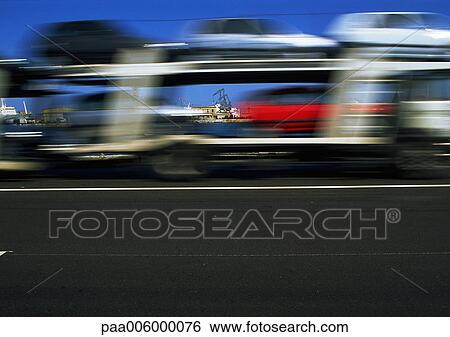Truck carrying cars in motion, blurry. View Large Photo Image Stock Photograph - Truck carrying cars in motion, blurry.. Fotosearch