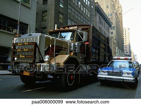 Stock Photo - USA, truck next to police car on city street. Fotosearch