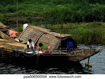 Vietnam, people on dock next to houseboat View Large Photo Image Stock Photograph - Vietnam, people on dock next to houseboat. Fotosearch