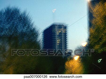 Stock Photograph - France, Paris, building and trees, blurred. Fotosearch