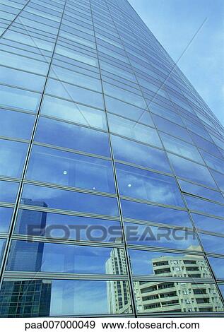 Stock Photo - France, Paris, buildings reflected in glass facade of skyscraper. Fotosearch