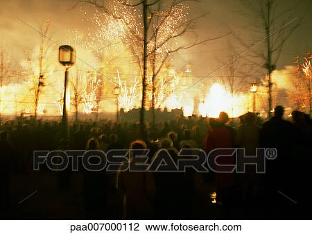 Stock Image - France, Paris, people watching fireworks at night, blurred. Fotosearch