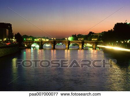 Stock Photo - France, Paris, River Seine at dusk. Fotosearch