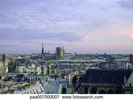 Stock Photo - France, Paris, rooftop view of at sunset. Fotosearch