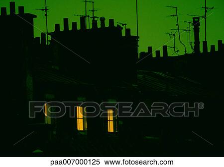 Stock Photography - France, Paris, rooftops in silhouette at night. Fotosearch