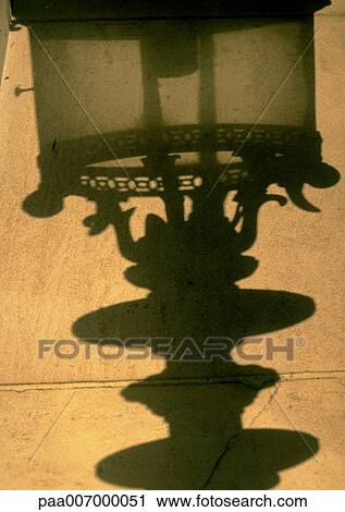 Stock Image - France, Paris, shadow of street lamp on wall. Fotosearch