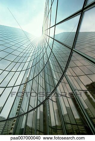 Stock Image - France, Paris, skyscraper with glass facade, reflection, low angle view. Fotosearch