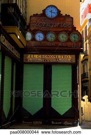 Picture - Collection of signs and clocks on street corner.. Fotosearch