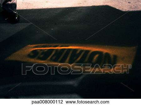 Stock Image - Notaries text in french stenciled on street.. Fotosearch