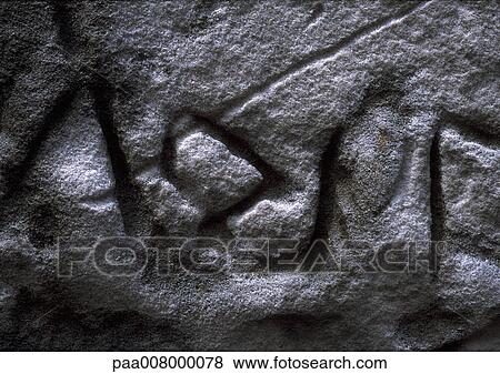 Stock Photo - Writing engraved in stone wall.. Fotosearch