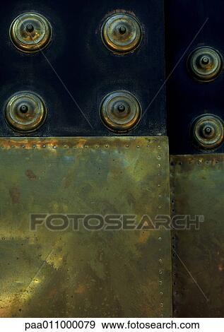 Brass overlays on dark wood, close-up View Large Photo Image Stock Photo - Brass overlays on dark wood, close-up. Fotosearch
