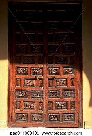 Carved wooden doors, in part shadow View Large Photo Image Stock Photography - Carved wooden doors, in part shadow. Fotosearch