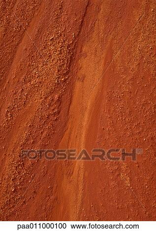 Stock Image - Red sand, close-up. Fotosearch