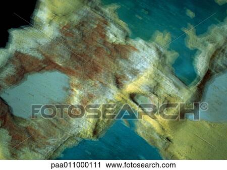 Stock Image - Rough, blue and yellow chipped surface, blurred. Fotosearch