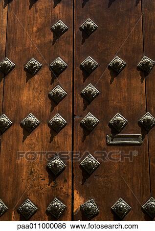 Wooden door with brass studs, close-up View Large Photo Image Stock Photograph - Wooden door with brass studs, close-up. Fotosearch