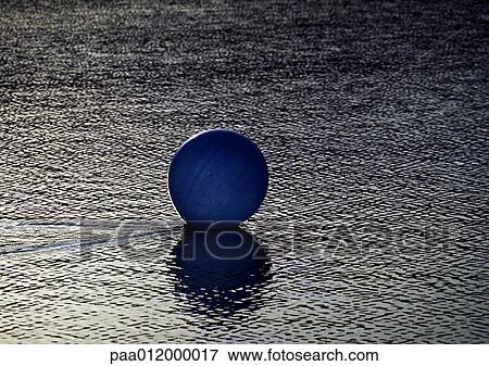 Ball on wet sand View Large Photo Image Stock Photo - Ball on wet sand. Fotosearch