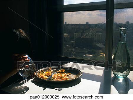 Child drinking from glass, sitting at table with plate of food and carafe of water View Large Photo Image Stock Photography - Child drinking from glass, sitting at table with plate of food and carafe of water. Fotosearch