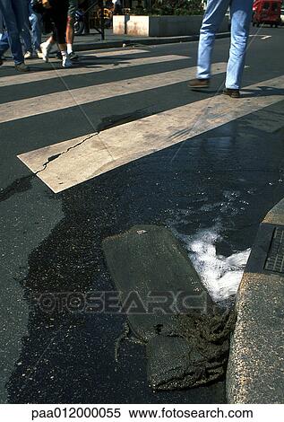 Crosswalk water pouring into gutter View Large Photo Image Stock Photography - Crosswalk water pouring into gutter. Fotosearch